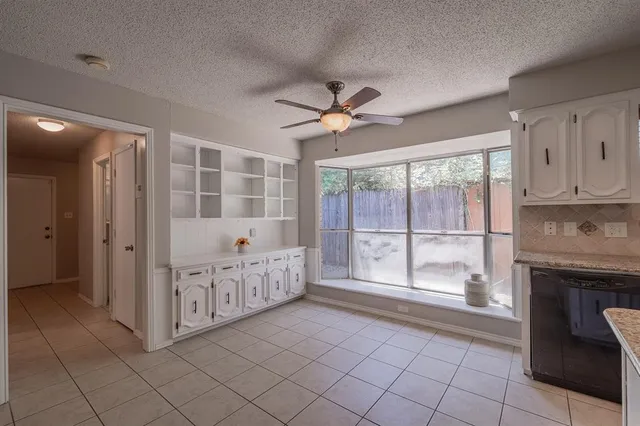 a spacious bedroom with furniture and a fireplace