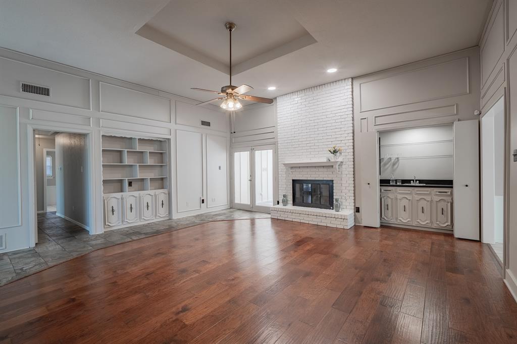 3316 Appalachian Way Plano, TX 75075 - Photo 9 of 29 an empty room with wooden floor fireplace and windows