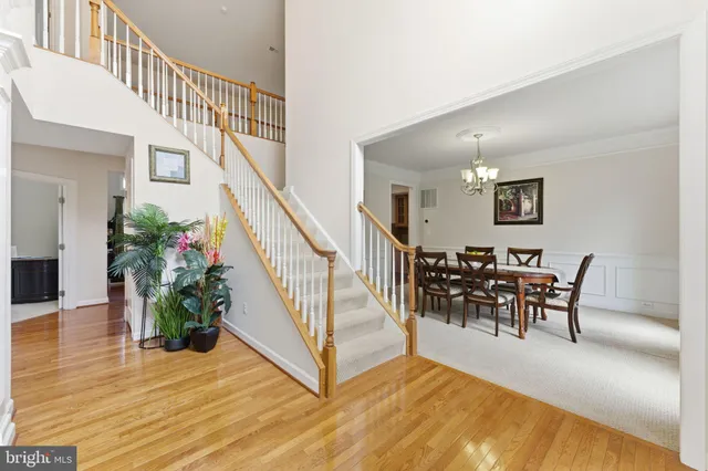 a dining room with furniture a chandelier and wooden floor