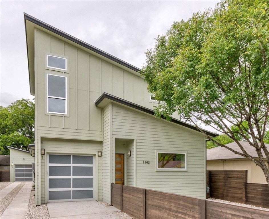 1142 Brookswood Avenue, Unit 1 Austin, TX 78721 - Photo 1 of 1 a front view of a house with large windows