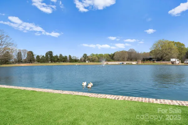 a view of a lake with houses in the background