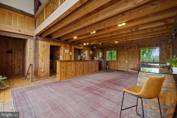 a dining room with furniture and wooden floor