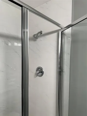 a bathroom with a glass shower door