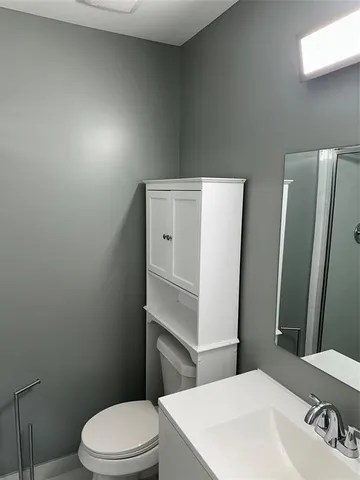 a bathroom with a sink a toilet and vanity