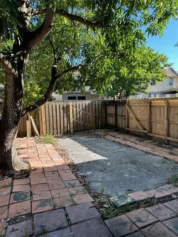 a view of small yard with wooden fence