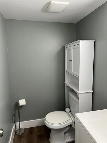 a white toilet sitting next to a bathroom sink