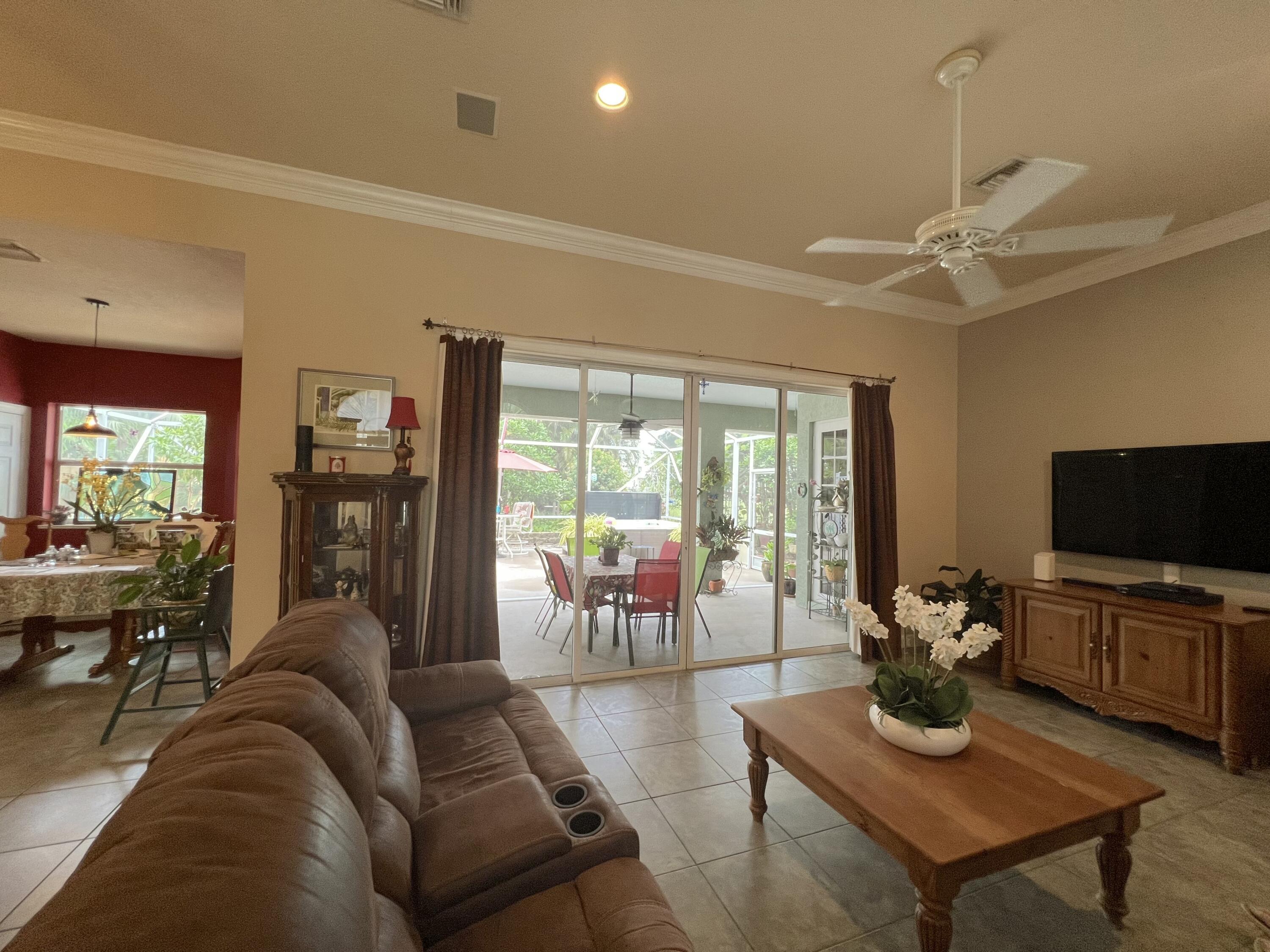 4292 Southeast Rainbows End Stuart, FL 34997 - Photo 20 of 53 a living room with furniture and a flat screen tv