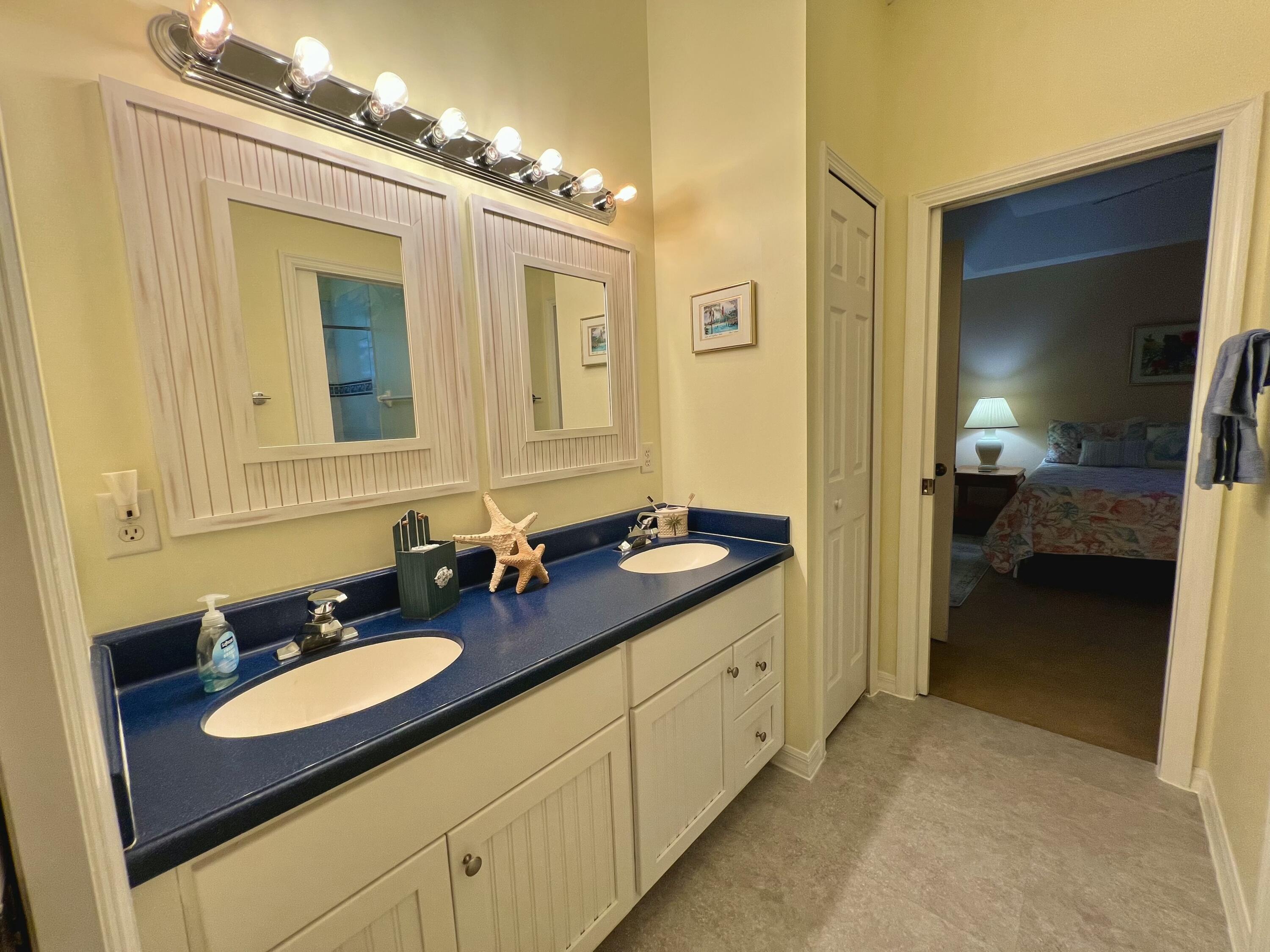 4292 Southeast Rainbows End Stuart, FL 34997 - Photo 28 of 53 a en suite bathroom with double sink and a mirror