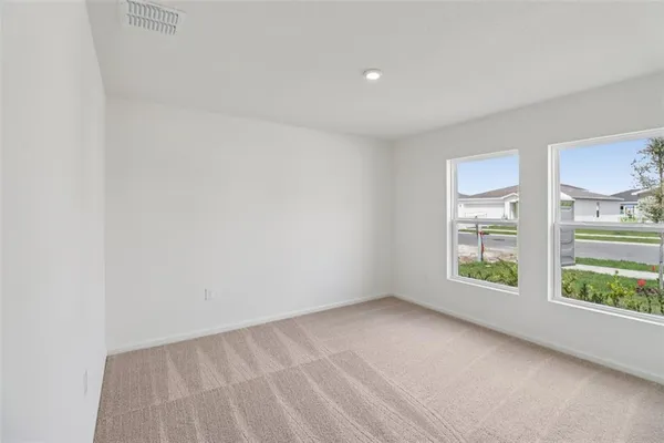 an empty room with windows and view