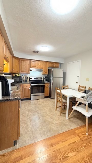 1105 Lexington Street, Unit 84 Waltham, MA 02452 - Photo 6 of 9 a living room with stainless steel appliances kitchen island granite countertop furniture and a kitchen view