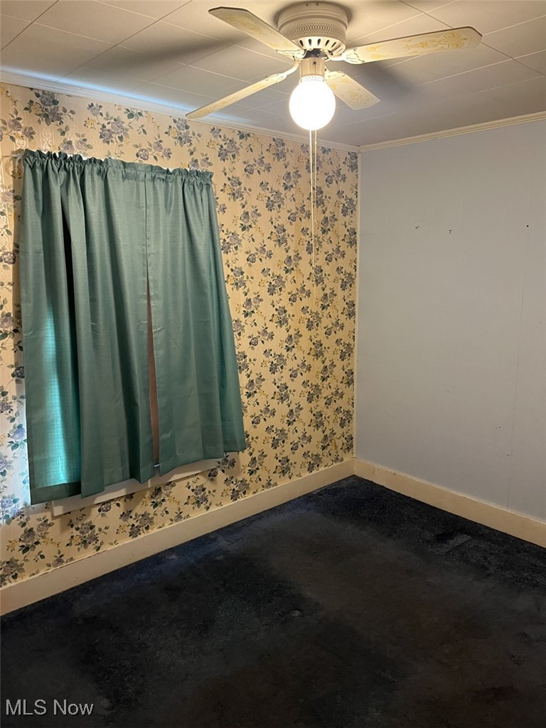 2081 Antigua Road Southwest Carrollton, OH 44615 - Photo 9 of 15 Carpeted bedoom with crown molding, wallpapered walls, and ceiling fan