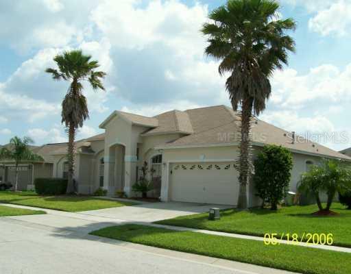 13037 Jewelstone Way Orlando, FL 32828 - Photo 1 of 1 a front view of a house with a yard and garage