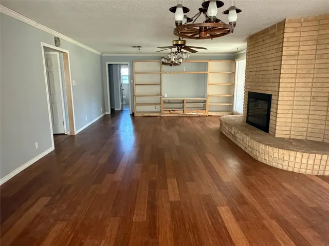 a view of a room with wooden floor and staircase