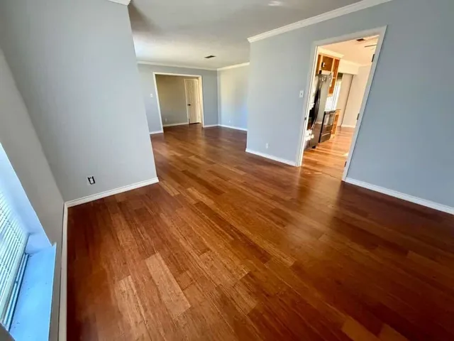 an empty room with windows and cabinet