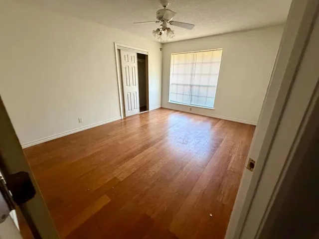 wooden floor in an empty room with a mirror