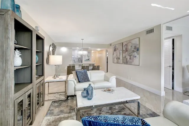 a living room with furniture a rug and a painting on the wall