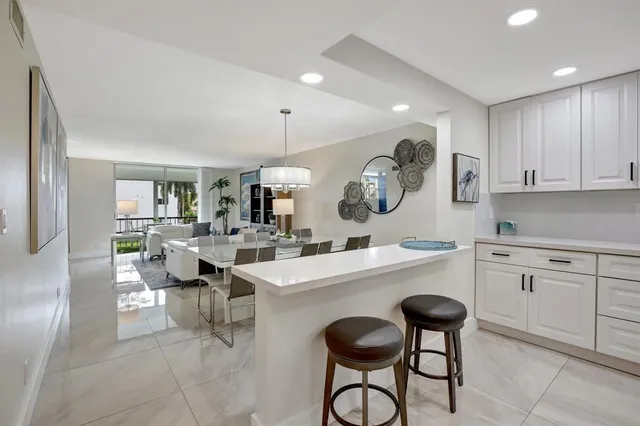 a kitchen with a sink a counter space stainless steel appliances and cabinets