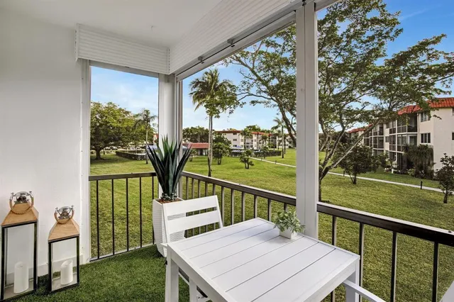 a view of a porch with furniture and garden