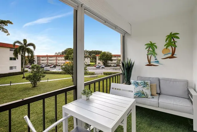 a view of a balcony with lake view and a potted plant