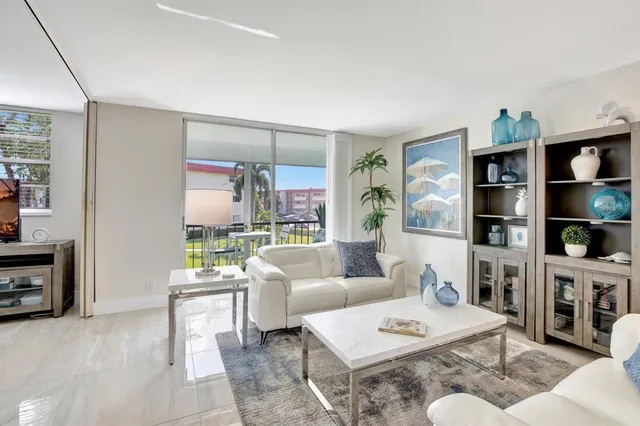 a living room with furniture and a book shelf