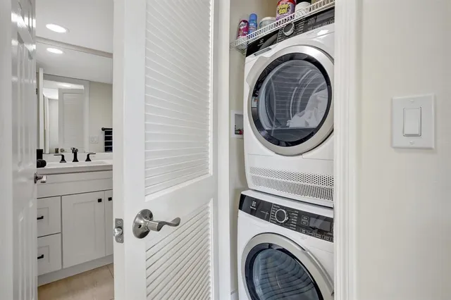 a bathroom with a sink and a washer dryer