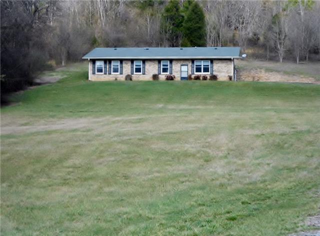 6 Acres, with treed area behind the home and cleared trails.