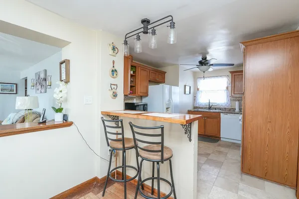 a kitchen with stainless steel appliances kitchen island granite countertop a sink and cabinets