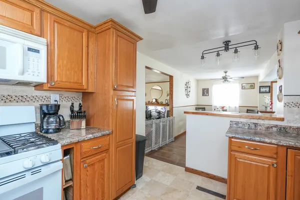 a kitchen with granite countertop cabinets stainless steel appliances and a counter top