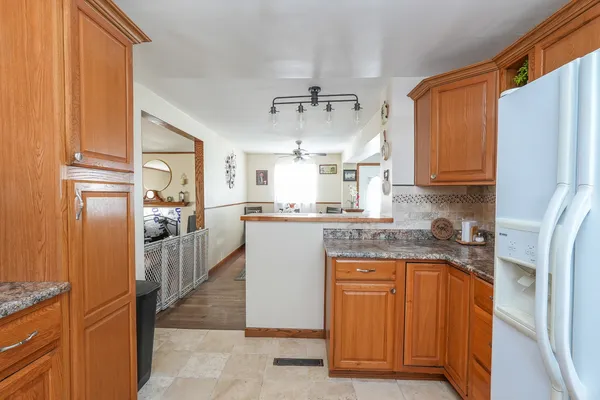 a kitchen with stainless steel appliances granite countertop a refrigerator and a stove