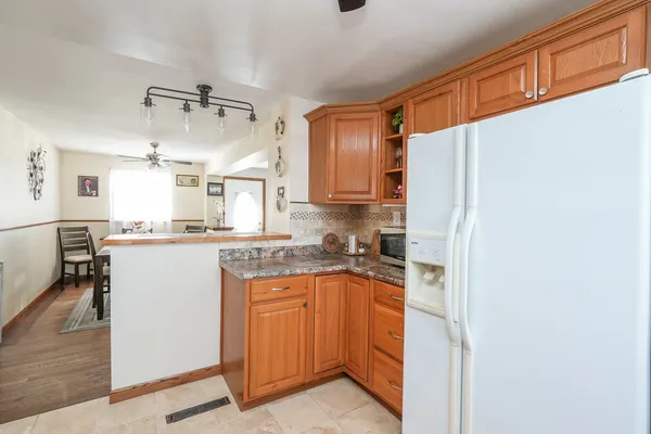 a kitchen with a refrigerator a sink and cabinets