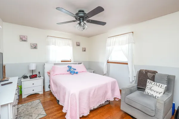 a bedroom with a bed couch and window