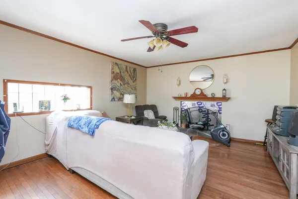 a living room with furniture and wooden floor