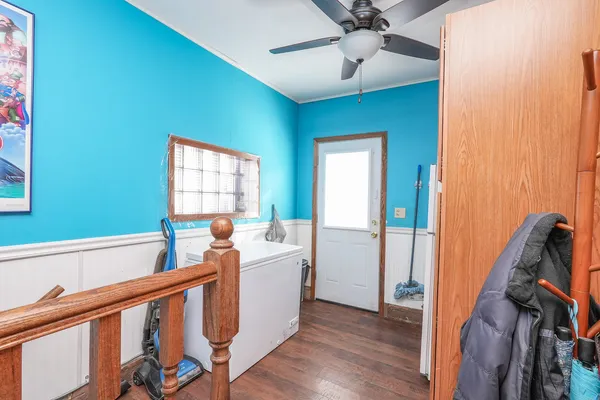 a view of a hallway with a window and wooden floor