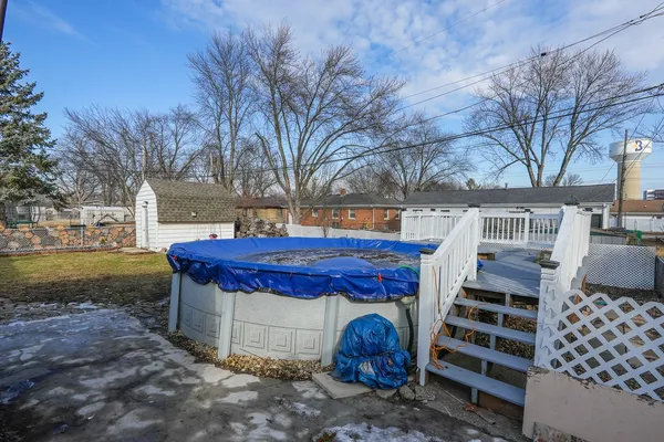 a view of a chairs and fire pit in the yard