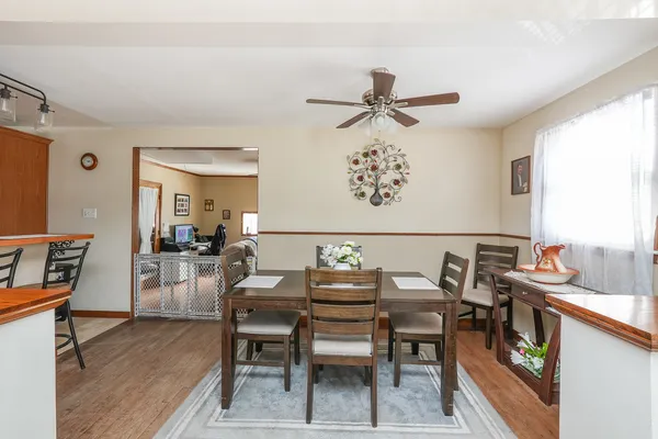 a view of a dining room with furniture and a chandelier