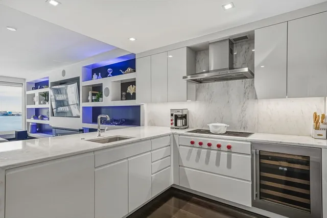 a bedroom with a bed and a lamp on dresser