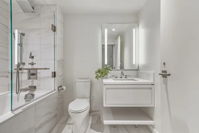 a bathroom with a shower and toilet