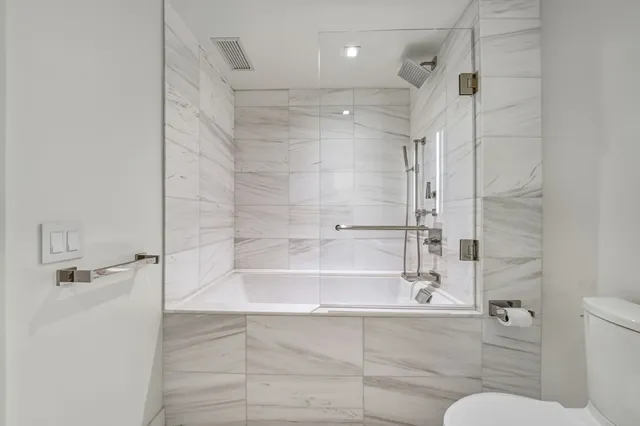 a living room with a bed and cabinets