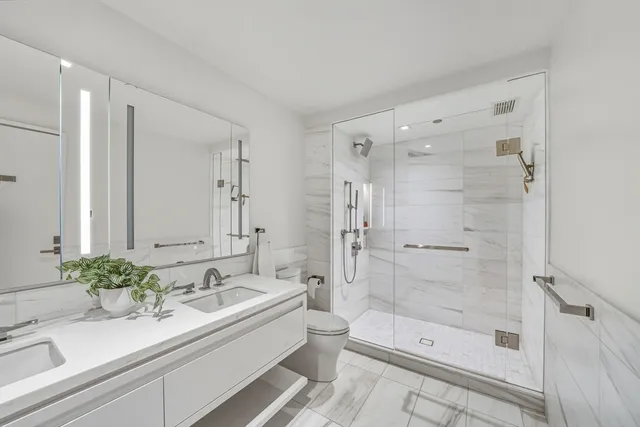 a bathroom with a tub a sink and mirror