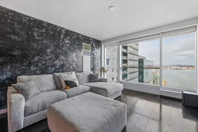 a living room with furniture and a floor to ceiling window
