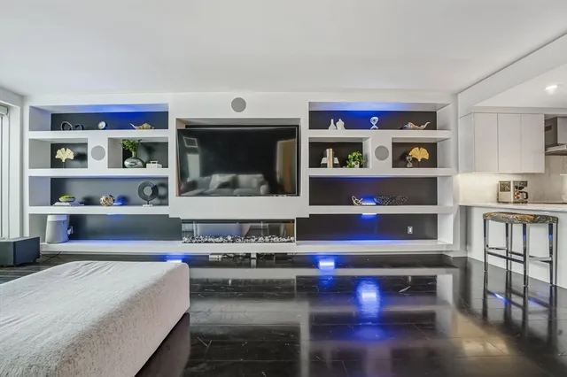 a bathroom with a granite countertop toilet sink and mirror