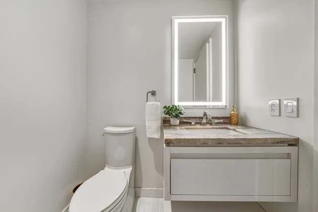 a kitchen with kitchen island a sink stove and refrigerator