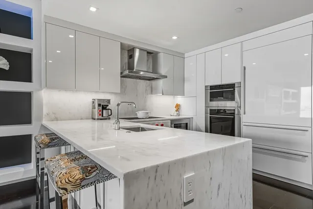 a kitchen with stainless steel appliances a stove and a refrigerator
