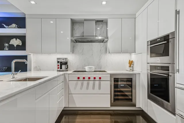 a kitchen with stainless steel appliances granite countertop a sink and cabinets