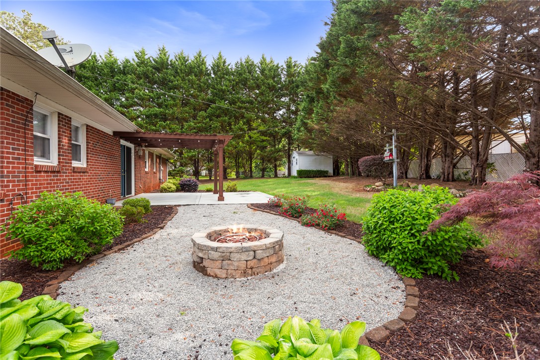 202 Keowee Trail Seneca, SC 29672 - Photo 30 of 35 Enjoy outdoor gatherings around the fire pit in this spacious yard, perfect for relaxation.