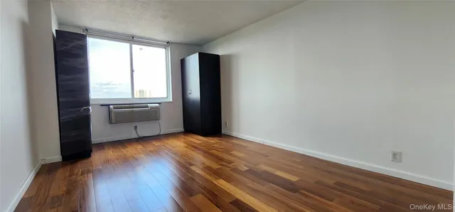 a view of a kitchen with wooden floor and electronic appliances