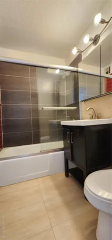 a bathroom with a sink a toilet and bathtub