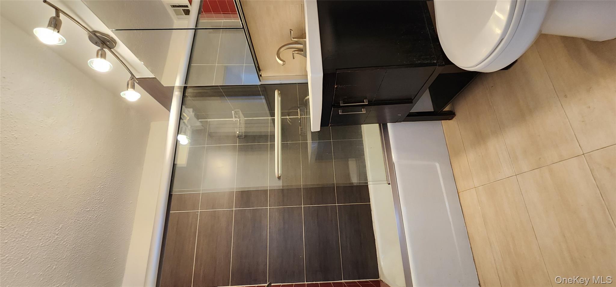 118-17 Union Turnpike, Unit 14E Queens, NY 11375 - Photo 14 of 24 a bathroom with a sink a toilet and bathtub