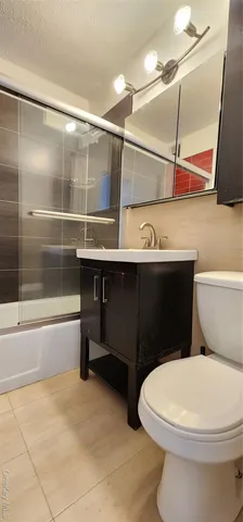 a bathroom with a sink a toilet and bathtub