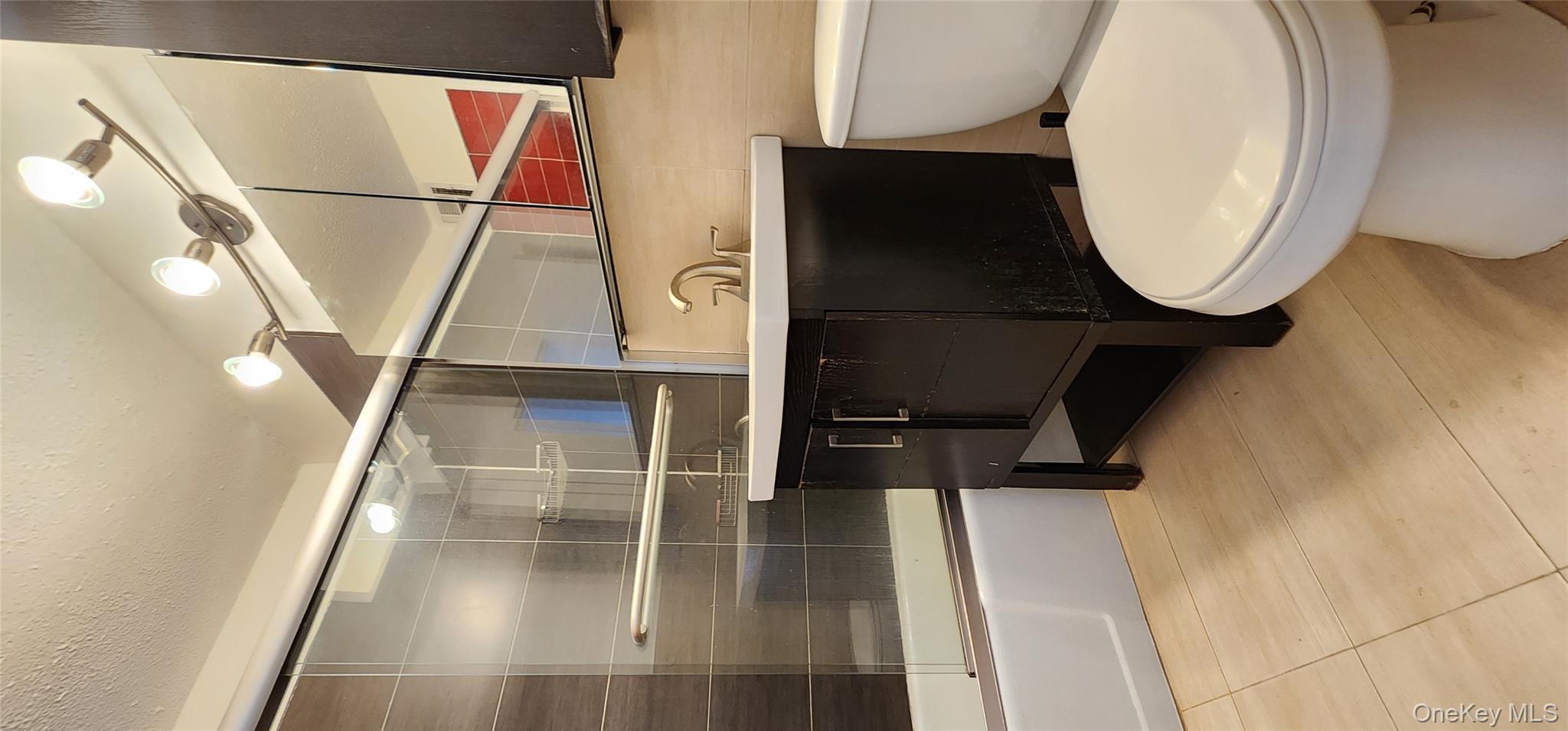 118-17 Union Turnpike, Unit 14E Queens, NY 11375 - Photo 15 of 24 a bathroom with a sink a toilet and bathtub